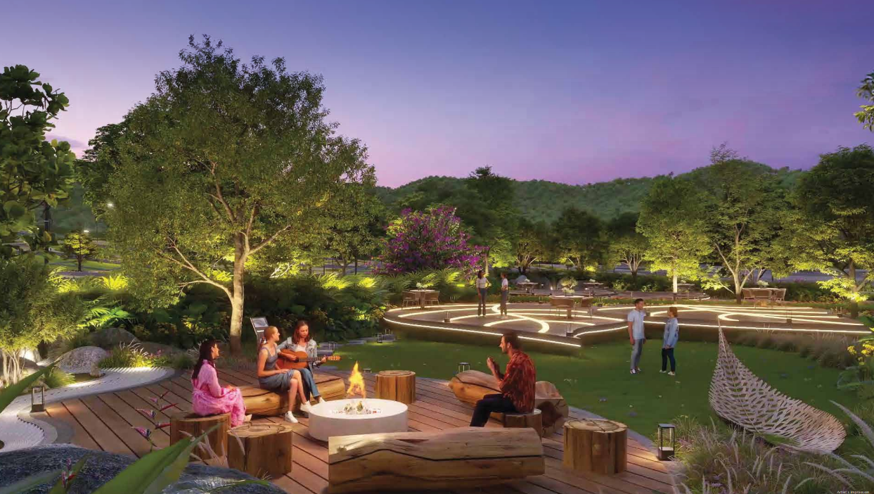 Artist’s impression of landscaped green spaces with a fire-pit deck and wooded hills at dusk